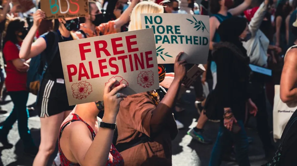 A Person Holding a Poster saying "Free Palestine"