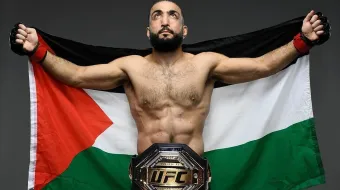 Belal Muhammad holding Palestinian flag during the weigh-ins
