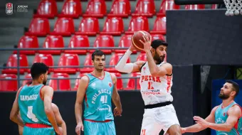 Basketball player avoiding three defenders