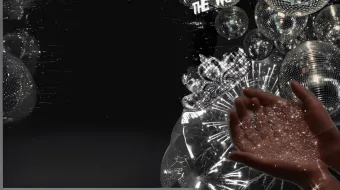 Disco ball in the night sky with hands